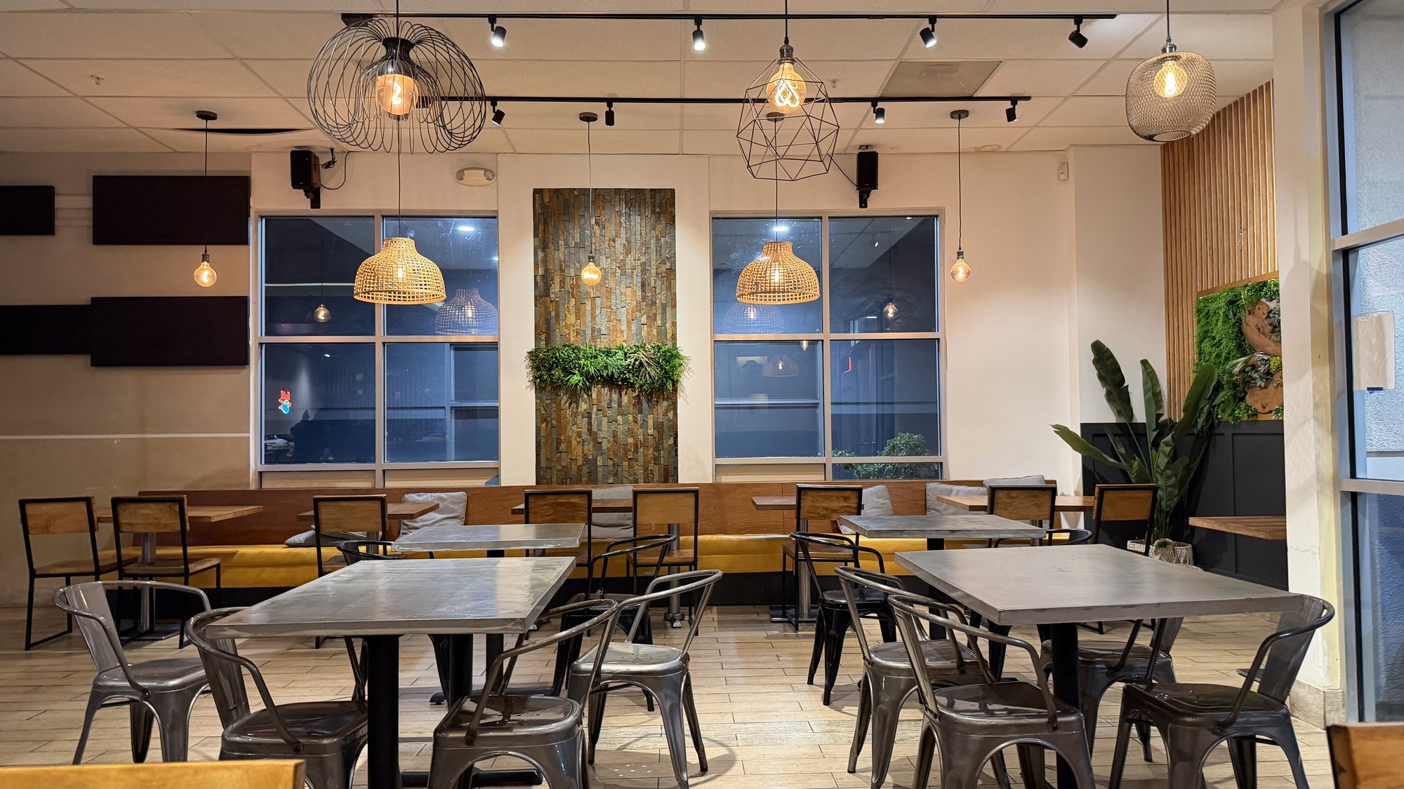 Stone feature wall, living greenery and rattan pendants